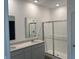 Modern bathroom with double vanity, a shower with glass door, and neutral colors at 3915 Donaldson Creek Ct, Clayton, IN 46118