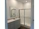 Clean bathroom featuring a glass enclosed shower, modern vanity with quartz countertop and rectangular mirror at 3915 Donaldson Creek Ct, Clayton, IN 46118