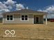 Exterior shot of back of the house with siding and large windows, plus a grassy backyard at 3915 Donaldson Creek Ct, Clayton, IN 46118
