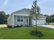 Single story home with a well-maintained lawn, complimented by a young tree and neutral siding at 3915 Donaldson Creek Ct, Clayton, IN 46118