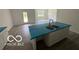 Bright, open kitchen area features a large island with double sink and white cabinets at 3915 Donaldson Creek Ct, Clayton, IN 46118
