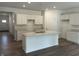 Modern kitchen featuring white cabinets, a central island, and hardwood floors at 3915 Donaldson Creek Ct, Clayton, IN 46118