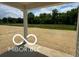 A covered patio overlooks the expansive backyard space and beyond at 3915 Donaldson Creek Ct, Clayton, IN 46118
