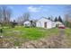 View of a large backyard with a play set and detached garage at 3924 E 30Th St, Indianapolis, IN 46218