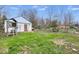 Backyard featuring a play set in front of a detached garage and a grassy lawn at 3924 E 30Th St, Indianapolis, IN 46218