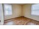 Modest bedroom featuring wood-look floors and natural light from the dual windows at 3924 E 30Th St, Indianapolis, IN 46218