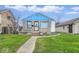 Charming single-story home with stone and siding, complemented by a well-manicured lawn and blue accents at 3924 E 30Th St, Indianapolis, IN 46218