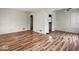 Spacious living room with wood-look floors, neutral walls, and an archway to another room at 3924 E 30Th St, Indianapolis, IN 46218