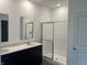 Bright bathroom featuring a double sink vanity with a modern shower and glass doors at 3933 Donaldson Creek Ct, Clayton, IN 46118