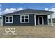 Rear exterior view of the home featuring a covered porch and spacious backyard at 3933 Donaldson Creek Ct, Clayton, IN 46118