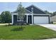 Charming home featuring blue siding, white trim, a spacious driveway, and a two-car garage at 3933 Donaldson Creek Ct, Clayton, IN 46118