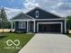 Charming single-story home boasts a well-manicured lawn, covered front porch, and attached two-car garage at 3933 Donaldson Creek Ct, Clayton, IN 46118