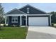 Charming home featuring blue siding, white trim, a spacious driveway, and a two-car garage at 3933 Donaldson Creek Ct, Clayton, IN 46118