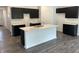 Modern kitchen featuring a large island with a white countertop and dark cabinetry at 3933 Donaldson Creek Ct, Clayton, IN 46118