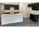 Modern kitchen featuring a large island with a white countertop and dark cabinetry at 3933 Donaldson Creek Ct, Clayton, IN 46118