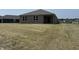 New home exterior featuring a spacious backyard and gray facade at 3949 Donaldson Creek Ct, Clayton, IN 46118