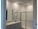 Modern bathroom featuring double sinks, quartz countertops, and a glass-enclosed shower at 3949 Donaldson Creek Ct, Clayton, IN 46118