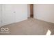 Neutrally carpeted room with white walls, door, and a glimpse into an adjacent space at 3949 Donaldson Creek Ct, Clayton, IN 46118