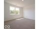 Carpeted bedroom showcasing natural light from the large window at 3949 Donaldson Creek Ct, Clayton, IN 46118