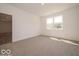 Carpeted bedroom with bright, natural light and access to other rooms at 3949 Donaldson Creek Ct, Clayton, IN 46118