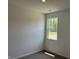 A bedroom with neutral walls, carpet, and a bright window view at 3949 Donaldson Creek Ct, Clayton, IN 46118