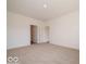 Large carpeted bedroom with neutral walls and access to other rooms at 3949 Donaldson Creek Ct, Clayton, IN 46118