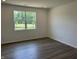 Bright bedroom featuring hardwood floors, white walls, recessed lighting, and a window at 3949 Donaldson Creek Ct, Clayton, IN 46118