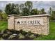 Stone monument sign at Fox Creek community entrance with manicured landscaping at 3949 Donaldson Creek Ct, Clayton, IN 46118