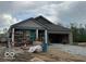 New construction home featuring a stone brick exterior, covered porch and attached two-car garage at 3949 Donaldson Creek Ct, Clayton, IN 46118