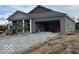 New construction home with stone brick exterior, attached garage and unfinished yard at 3949 Donaldson Creek Ct, Clayton, IN 46118