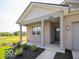 Inviting front porch with gray columns leads to a stylish home with a manicured garden at 3949 Donaldson Creek Ct, Clayton, IN 46118