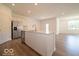 Spacious kitchen with stainless steel appliances, an island, and luxury vinyl flooring flowing into the living area at 3949 Donaldson Creek Ct, Clayton, IN 46118
