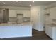 Bright kitchen featuring white cabinets, a kitchen island, recessed lighting, and hardwood floors at 3949 Donaldson Creek Ct, Clayton, IN 46118