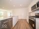Bright kitchen featuring stainless steel appliances, white cabinetry, and an island with a sink at 3949 Donaldson Creek Ct, Clayton, IN 46118