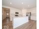 A modern kitchen featuring stainless steel appliances, white cabinets, and a central island at 3949 Donaldson Creek Ct, Clayton, IN 46118