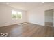 Living room with luxury vinyl plank flooring, natural light, and white walls at 3949 Donaldson Creek Ct, Clayton, IN 46118