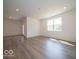 A spacious living room with luxury vinyl plank flooring, a door, and large windows at 3949 Donaldson Creek Ct, Clayton, IN 46118