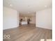 Living room with an open view to the kitchen, connected by luxury vinyl plank flooring at 3949 Donaldson Creek Ct, Clayton, IN 46118