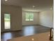Bright living room featuring hardwood floors, white walls, recessed lighting, a glass door and a window at 3949 Donaldson Creek Ct, Clayton, IN 46118