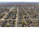 Overhead view of a residential area with tree-lined streets and a distant skyline at 3970 Broadway St, Indianapolis, IN 46205