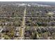 High-angle view of a suburban community, with tree cover and nearby racetrack at 3970 Broadway St, Indianapolis, IN 46205
