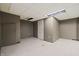 Unfinished basement with concrete floor and a white door at 3970 Broadway St, Indianapolis, IN 46205