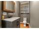 Bathroom featuring a modern vanity with gray wood grain and an open shelving cabinet at 3970 Broadway St, Indianapolis, IN 46205