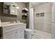 This bathroom features a tiled shower, sink and mirror at 3970 Broadway St, Indianapolis, IN 46205