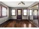 Bedroom with hardwood floors, natural light, and mirrored closet at 3970 Broadway St, Indianapolis, IN 46205