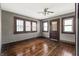 Empty room with hardwood floors, vintage ceiling fan and natural lighting at 3970 Broadway St, Indianapolis, IN 46205