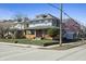 Charming two-story house with a brick porch, manicured lawn, and colorful flowering trees at 3970 Broadway St, Indianapolis, IN 46205