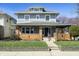 Charming two-story home with gray siding, brick accents, and a well-manicured front lawn under a clear blue sky at 3970 Broadway St, Indianapolis, IN 46205