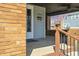 Covered front porch with brick pillars, ceiling fan, black security door, and house number 5970 at 3970 Broadway St, Indianapolis, IN 46205