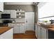 Well-lit kitchen featuring white cabinets, butcher block counters, and stainless steel appliances at 3970 Broadway St, Indianapolis, IN 46205